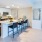 a kitchen with a bar and chairs