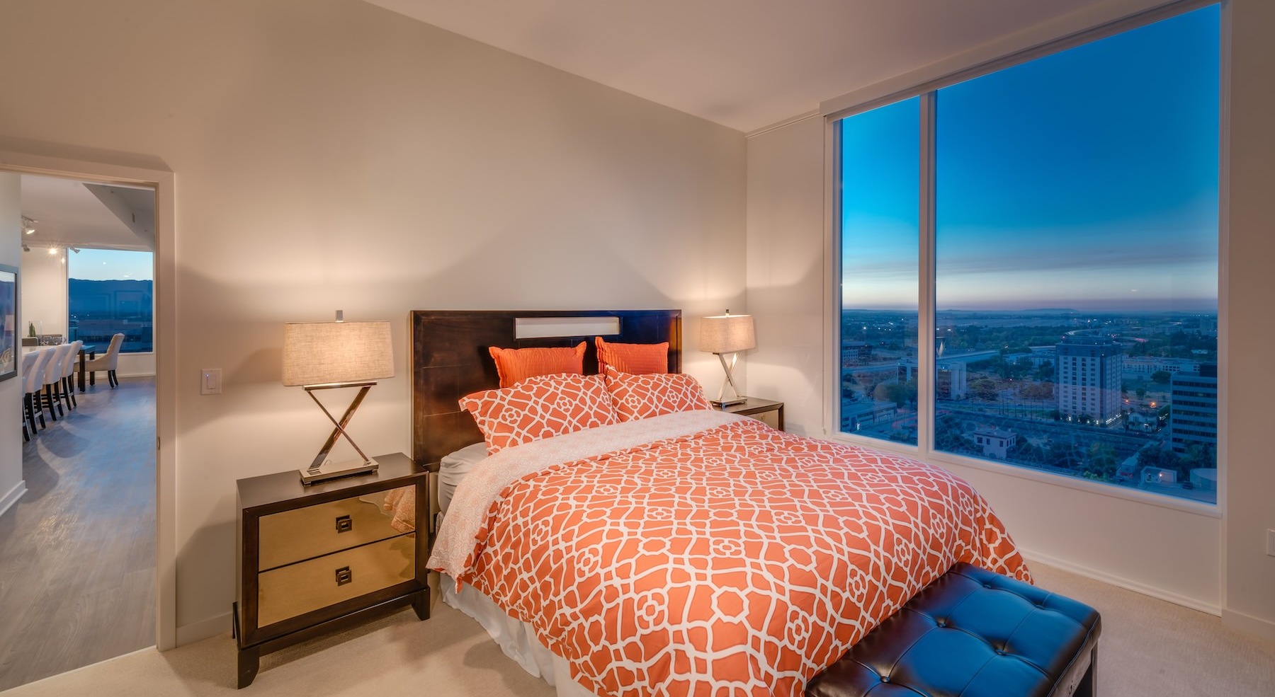 bedroom with nightstands and a large window