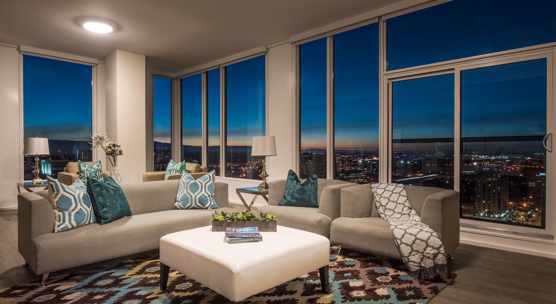 living room with a couch, table and large windows