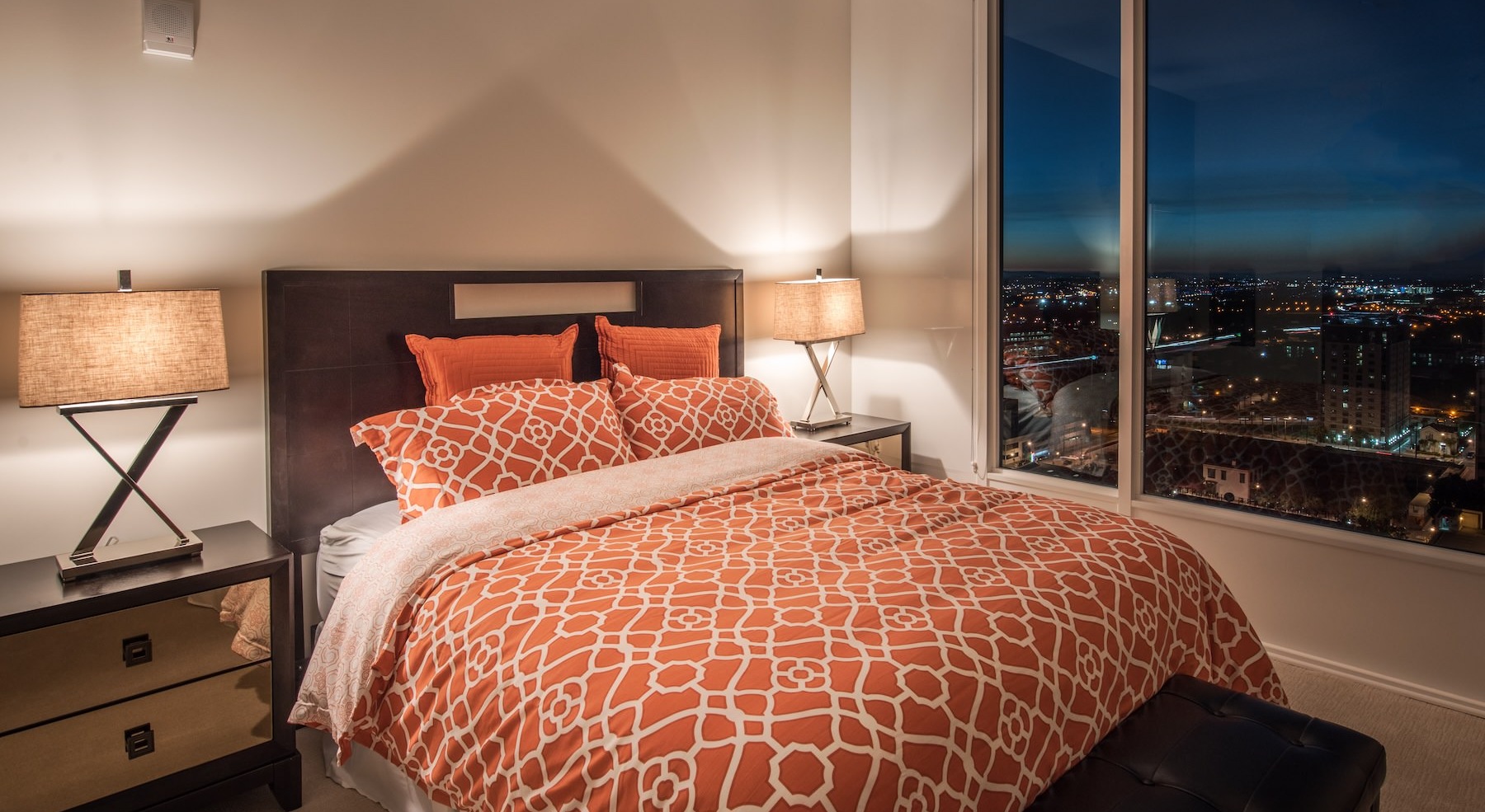 bedroom with nightstands and a large window
