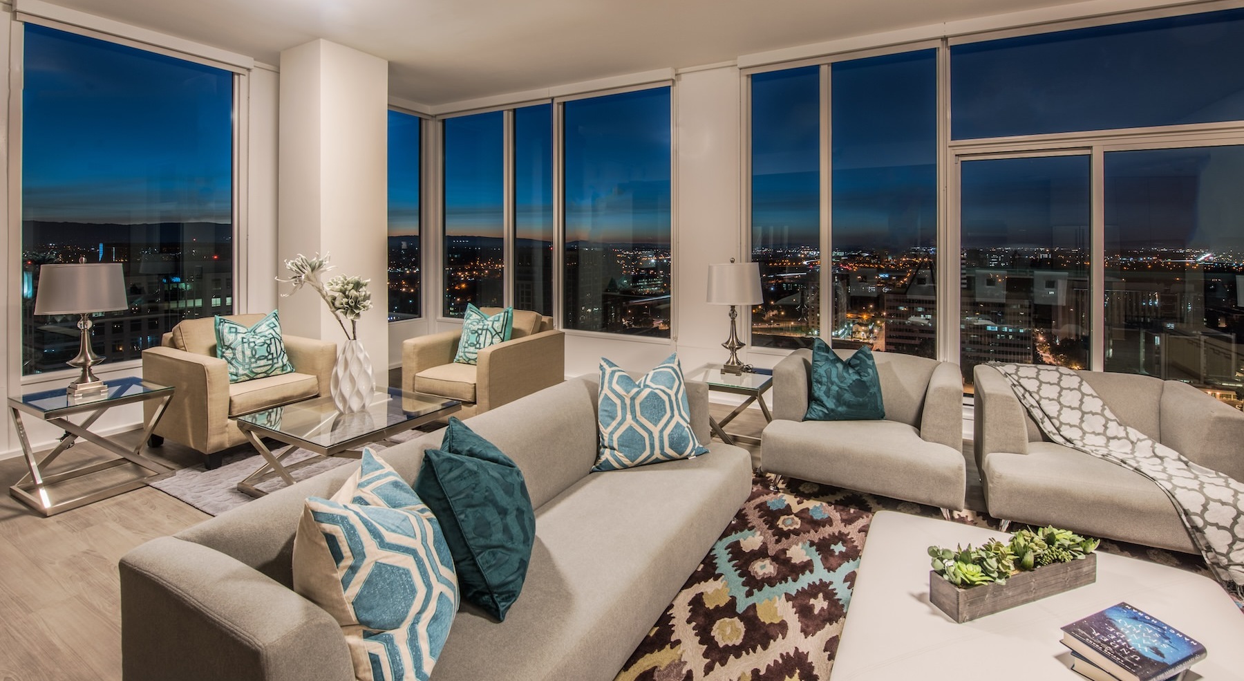 living room with a couch, table and large windows