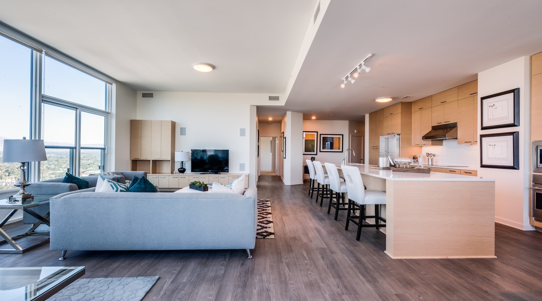 living room with a large couch, windows and a tv