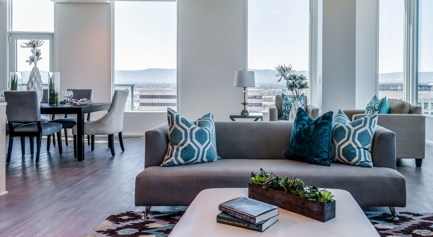 living room with a couch, table and large windows