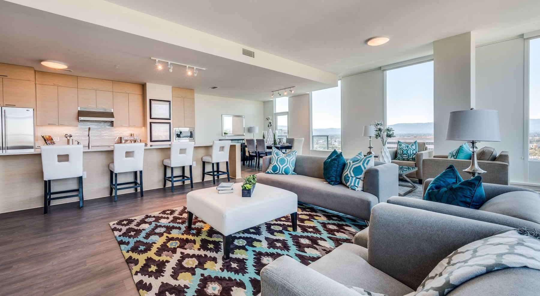 living room with a couch, table and large windows
