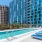 a swimming pool in front of a large building